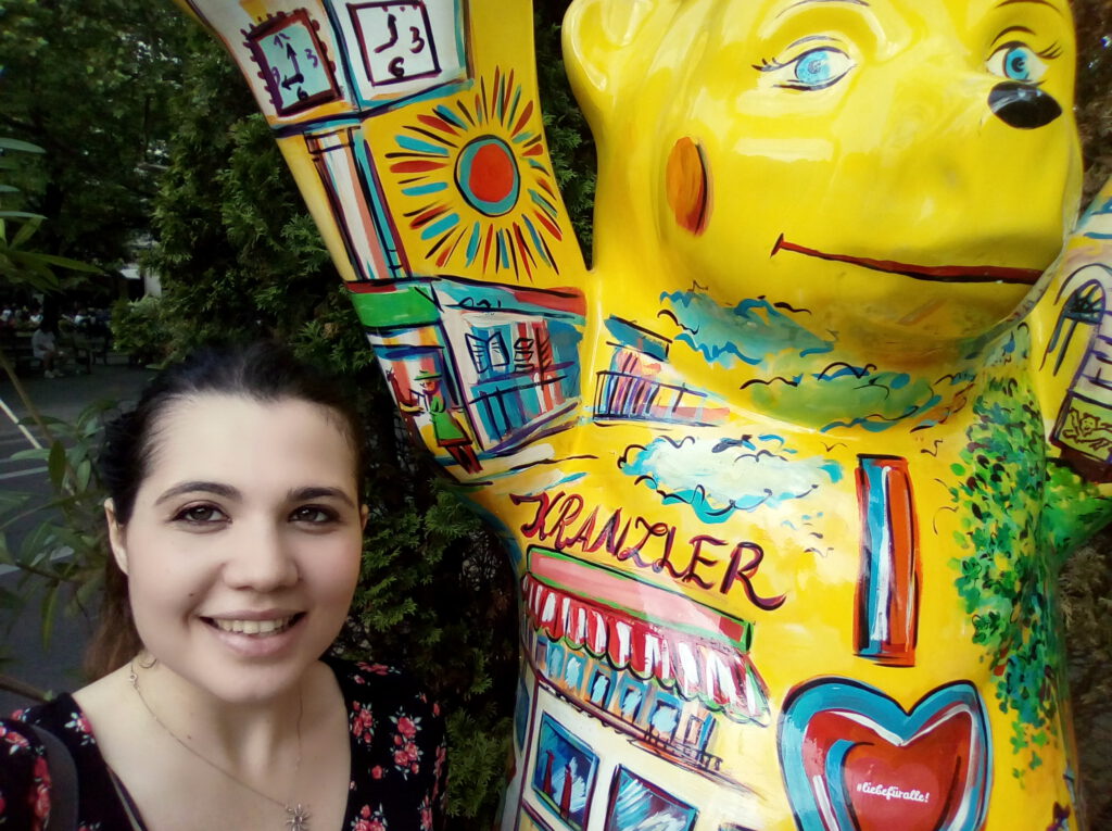 Volpato Elena (English-Italian translator) in Berlin next to a yellow plastic bear.